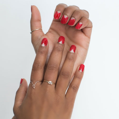 A tad more fun than your standard solid classic red nails. This fashionable set has a transparent triangle design where it meets your cuticle. A true versatile design that allows you to wear it for your meetings or to a girl’s night out.